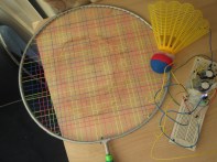 Badminton with coil and magnets producing electricity